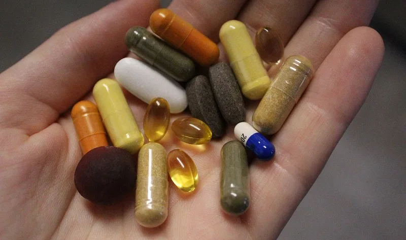 several colorful pills in an open hand