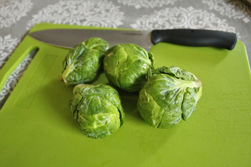 Fresh Brussels sprouts ready to be baked with garlic, part of an easy Brussels sprouts recipe.