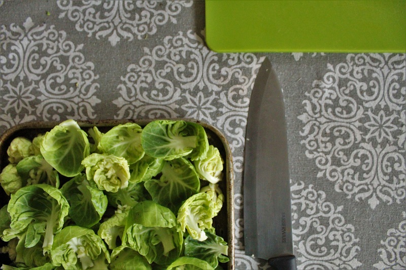 Chopped Brussels sprouts ready to be baked with garlic for a crispy and flavorful side dish.