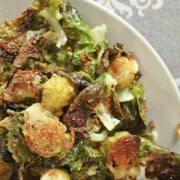A plate of easy baked Brussels sprouts with garlic, showing crispy, golden-brown sprouts seasoned perfectly.