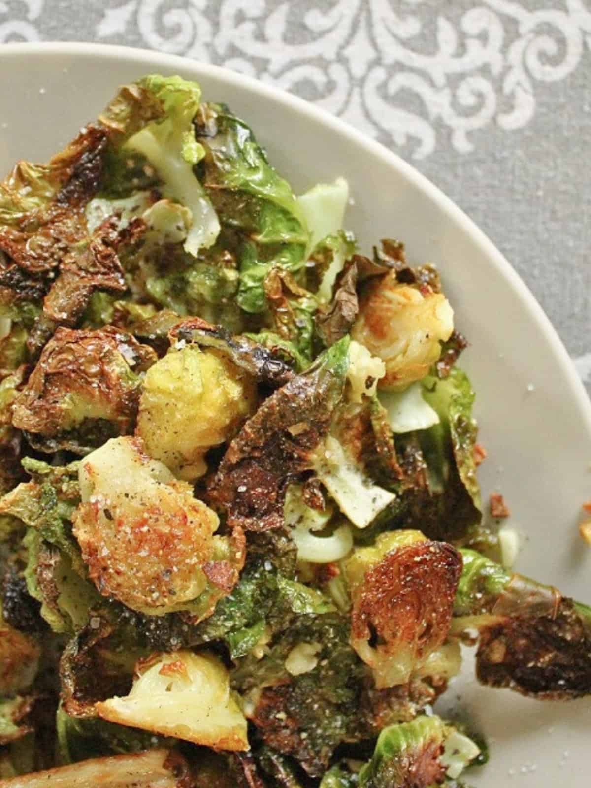 A plate of easy baked Brussels sprouts with garlic, showing crispy, golden-brown sprouts seasoned perfectly.