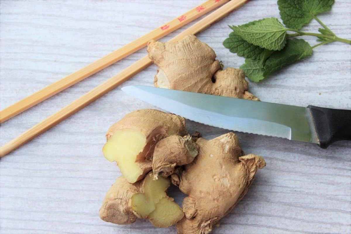 slices of fresh ginger root and mint leaves.