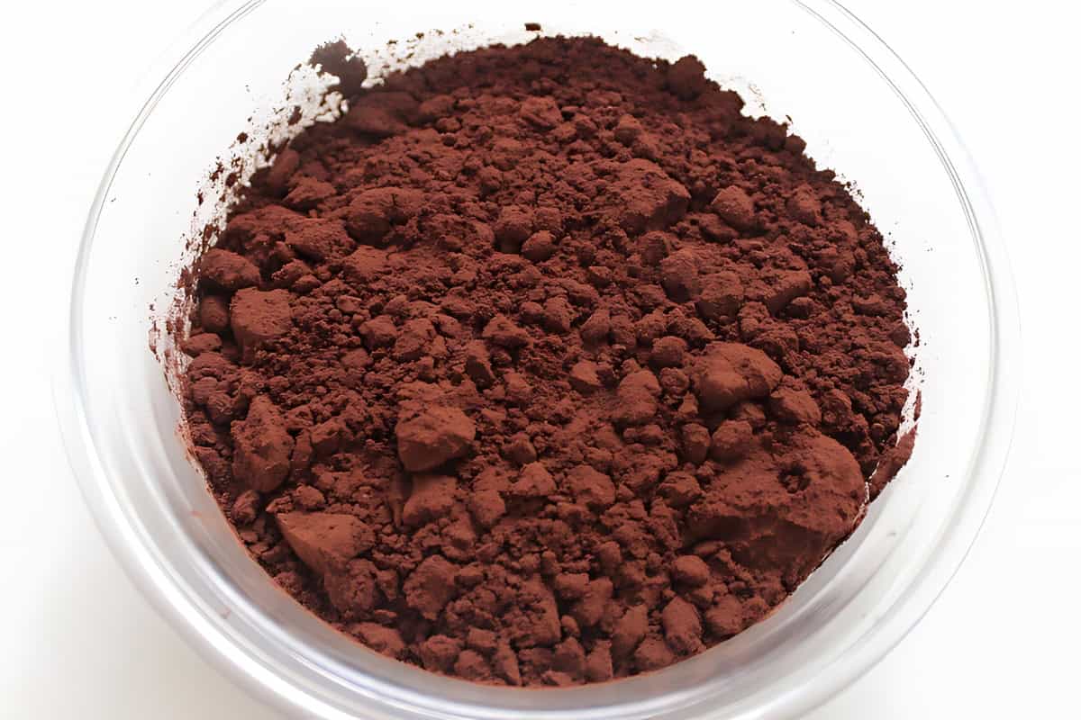 Dark tableya cocoa powder in a clear bowl.