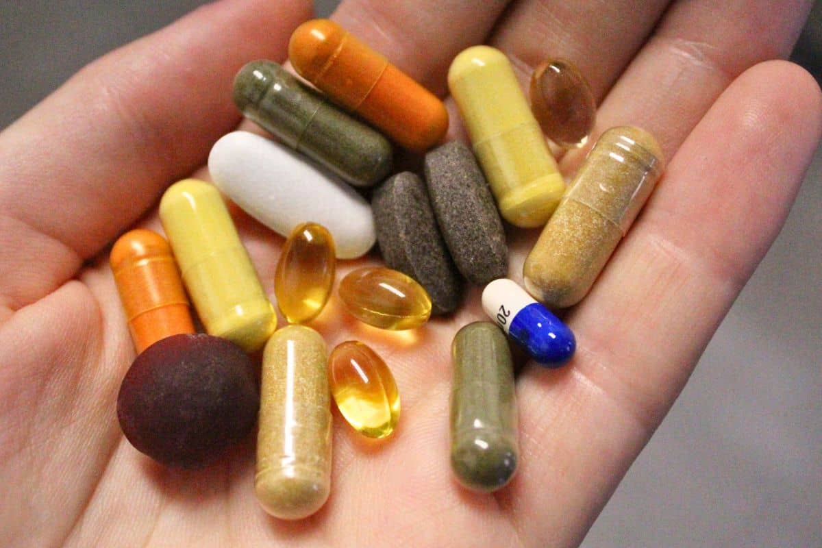 several colorful pills in an open hand.