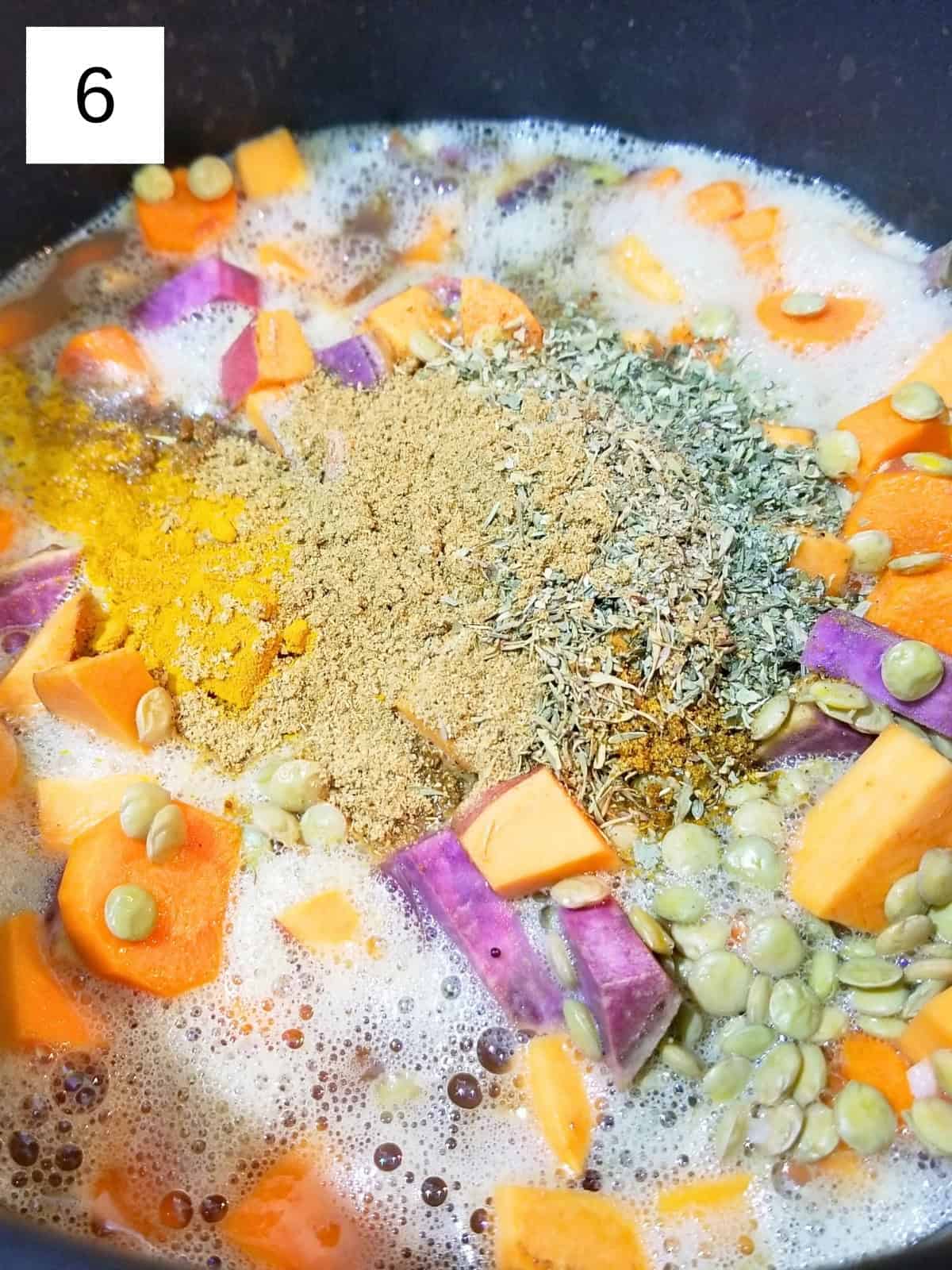 A mixture of nigella, mustard, lentils, broth, chopped carrots and sweet potato, and tomato paste, topped with spices.