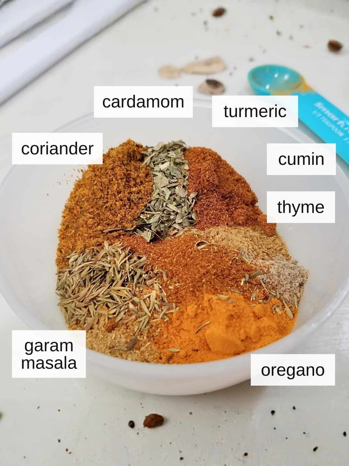 The herbs and spices blend added into the stew base, including coriander, cumin, cardamom, turmeric, thyme, oregano, and garam masala.