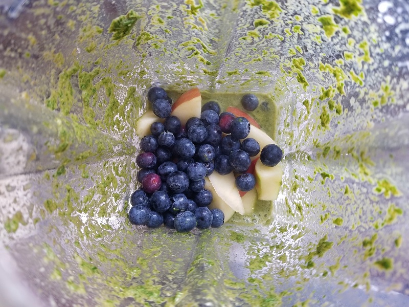 Step 3 for making a low histamine green smoothie, showcasing the blending process with fresh greens and low histamine ingredients.