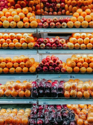 many different types of fruits are on display in a store.