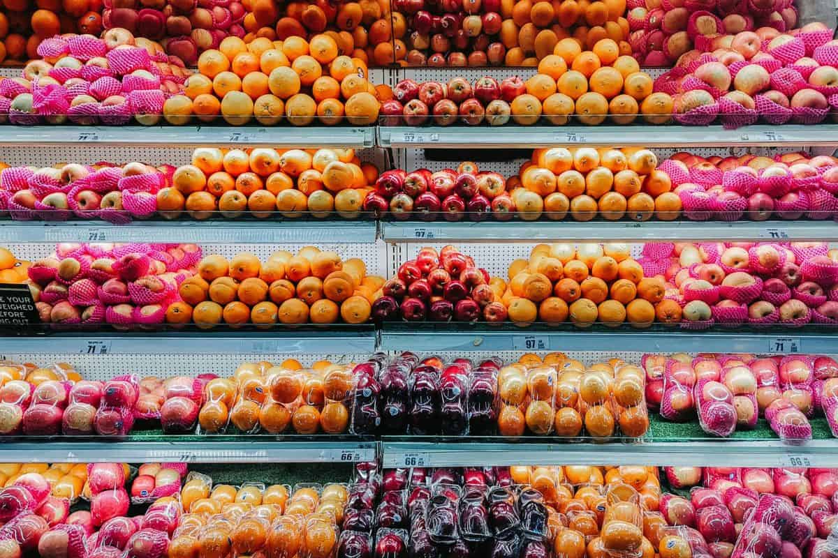 many different types of fruits are on display in a store.