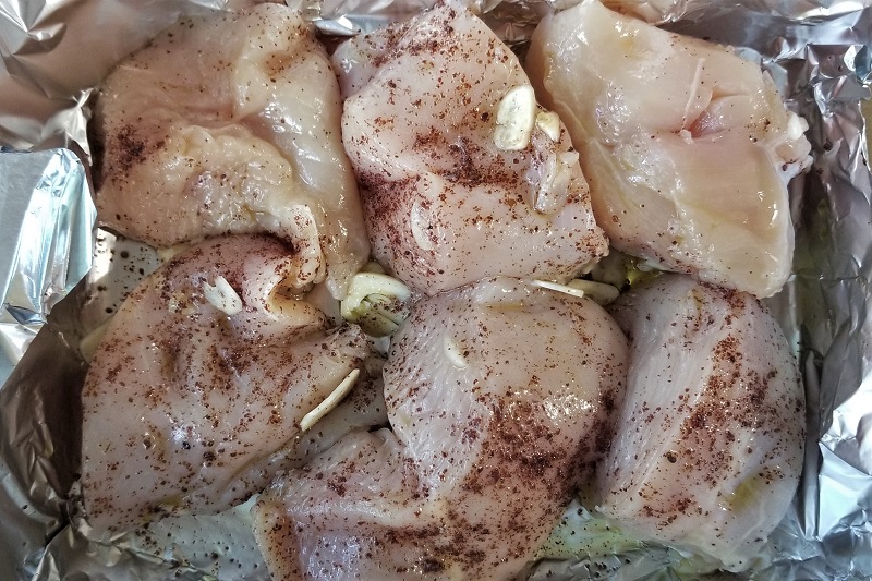 Chicken sprinkled with spices and garlic.