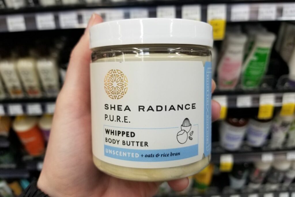 A person holding Shea radiance body butter.