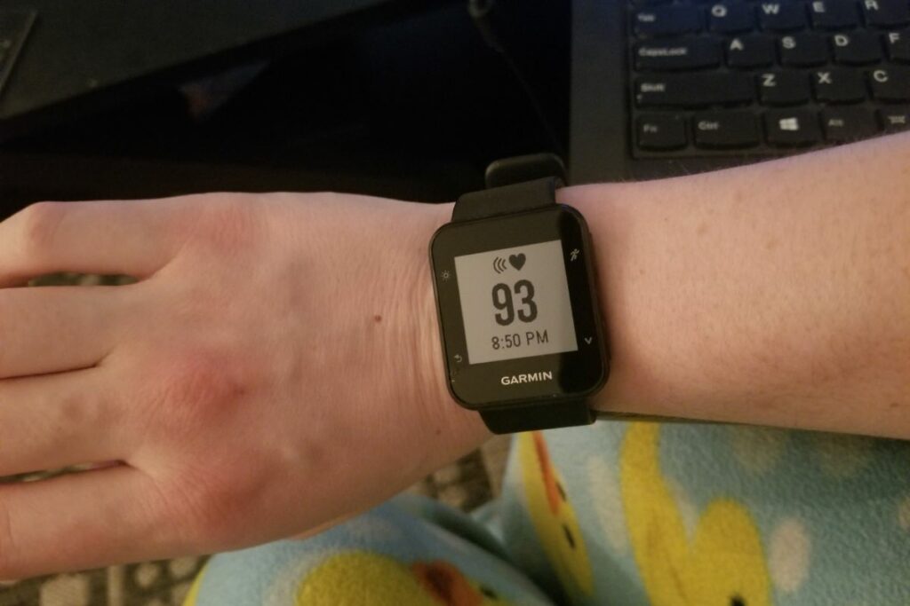 a person wearing a Garmin watch on their wrist.