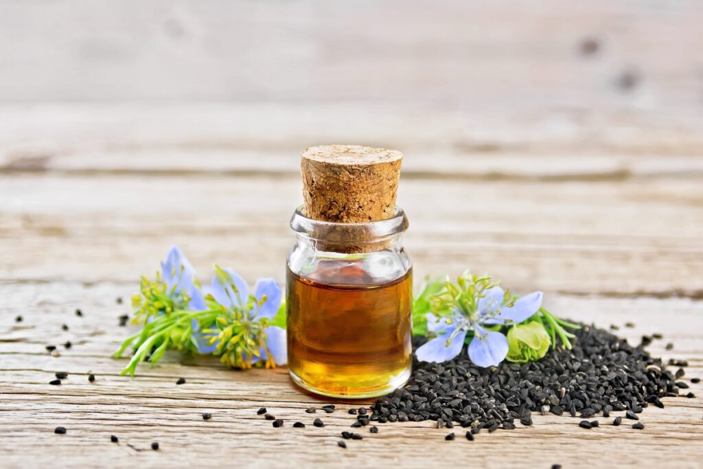 nigella sativa oil with some nigella seeds.