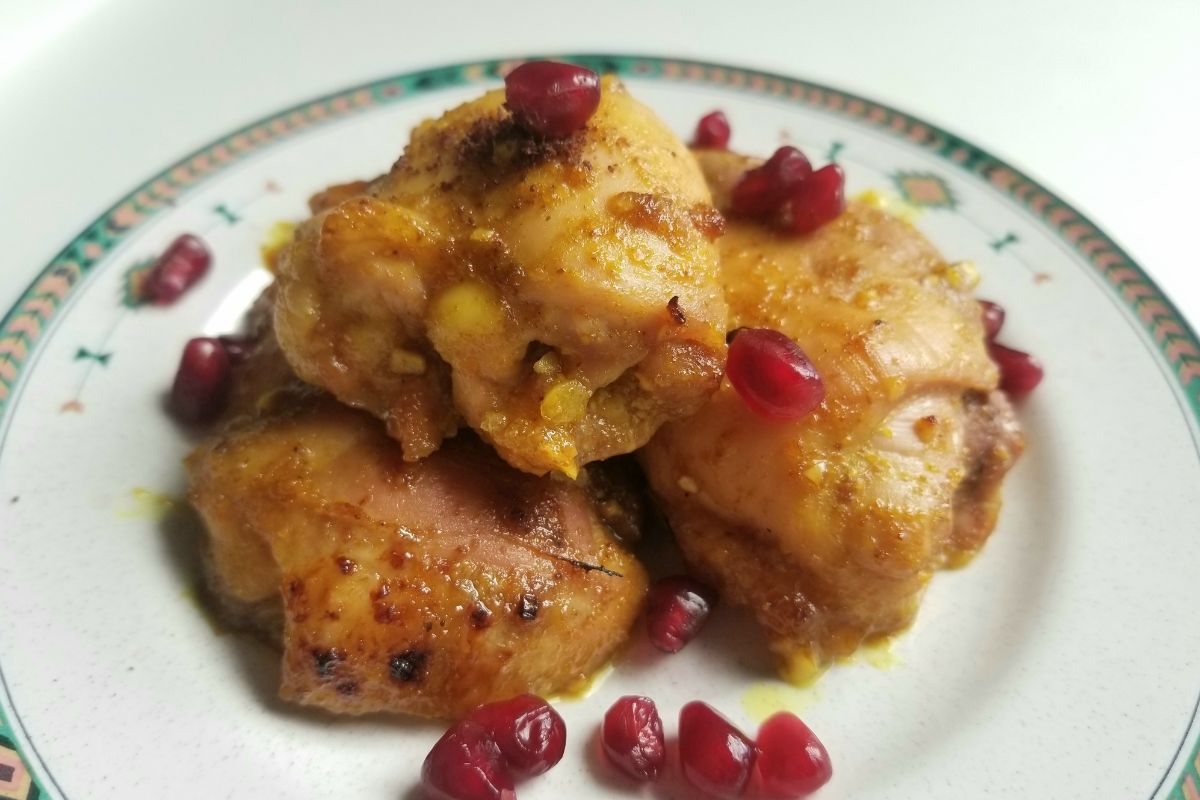 cooked honey turmeric chicken thighs on a plate.
