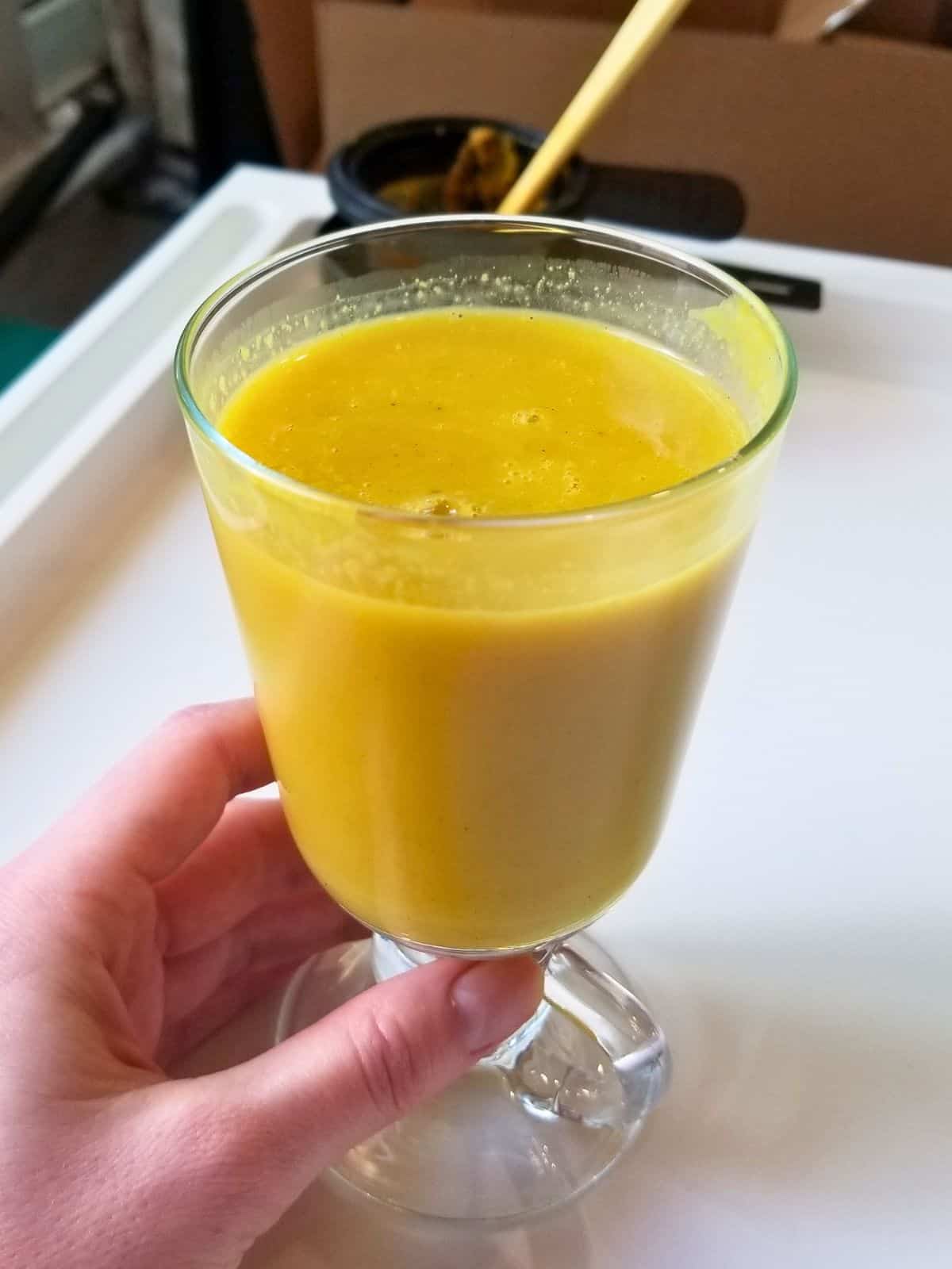 golden/turmeric milk latte in a drinking glass.