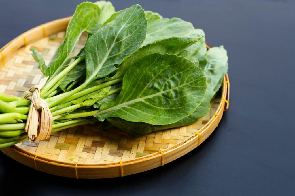 collard greens in a bamboo tray.