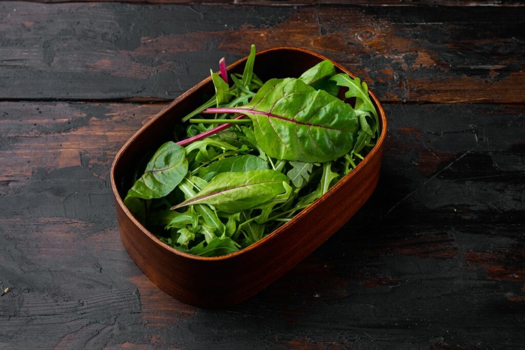 a container filled with fresh swiss chard.