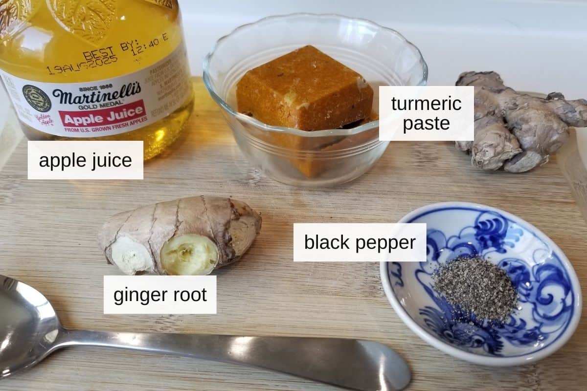 Ginger turmeric shots ingredients including apple juice, turmeric paste, ginger, and black pepper. 