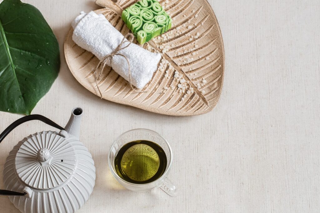 Herbal tea next to a towel and soap.