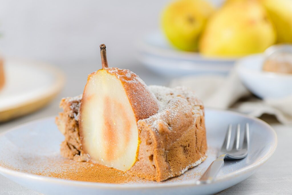 delicious cake slice with pear, ginger, and cinnamon on a plate.