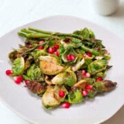 A plate of quick roasted asparagus and Brussels sprouts showcasing a simple and flavorful recipe.