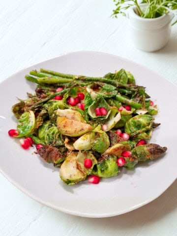 A plate of quick roasted asparagus and Brussels sprouts showcasing a simple and flavorful recipe.