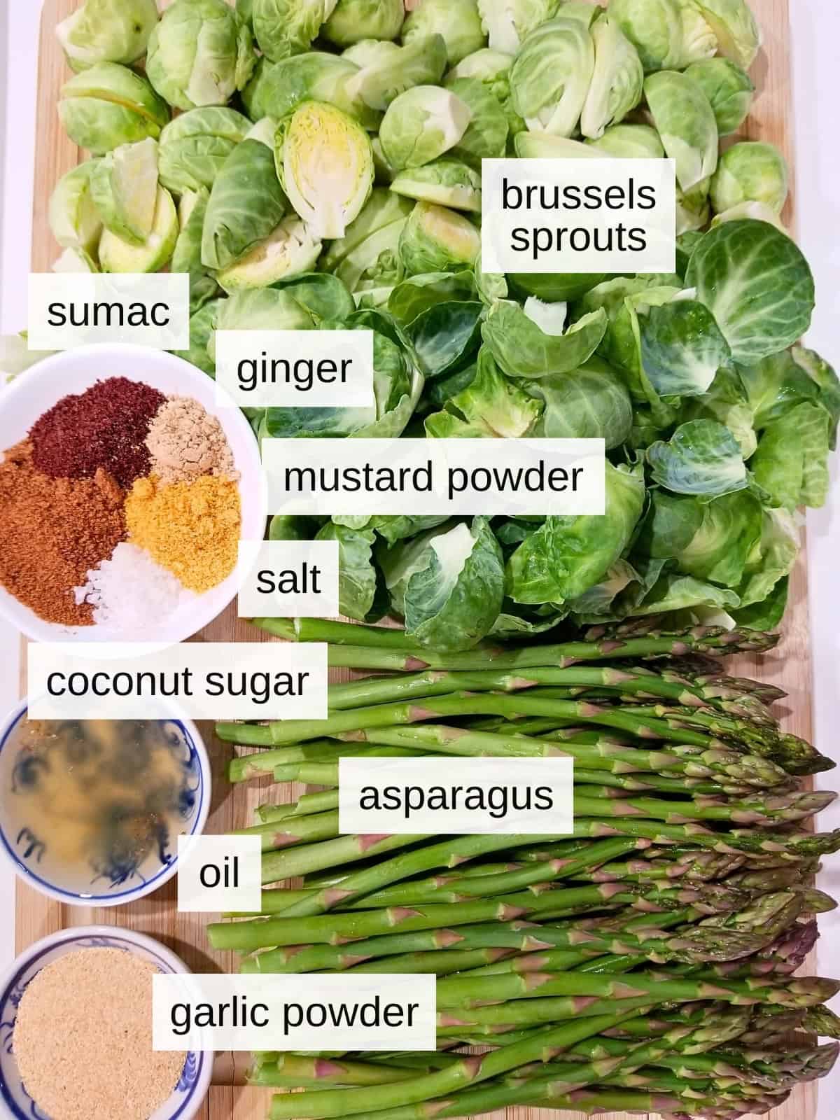 Ingredients used to make Roasted Asparagus & Brussels Sprouts, showcasing fresh asparagus and Brussels sprouts.