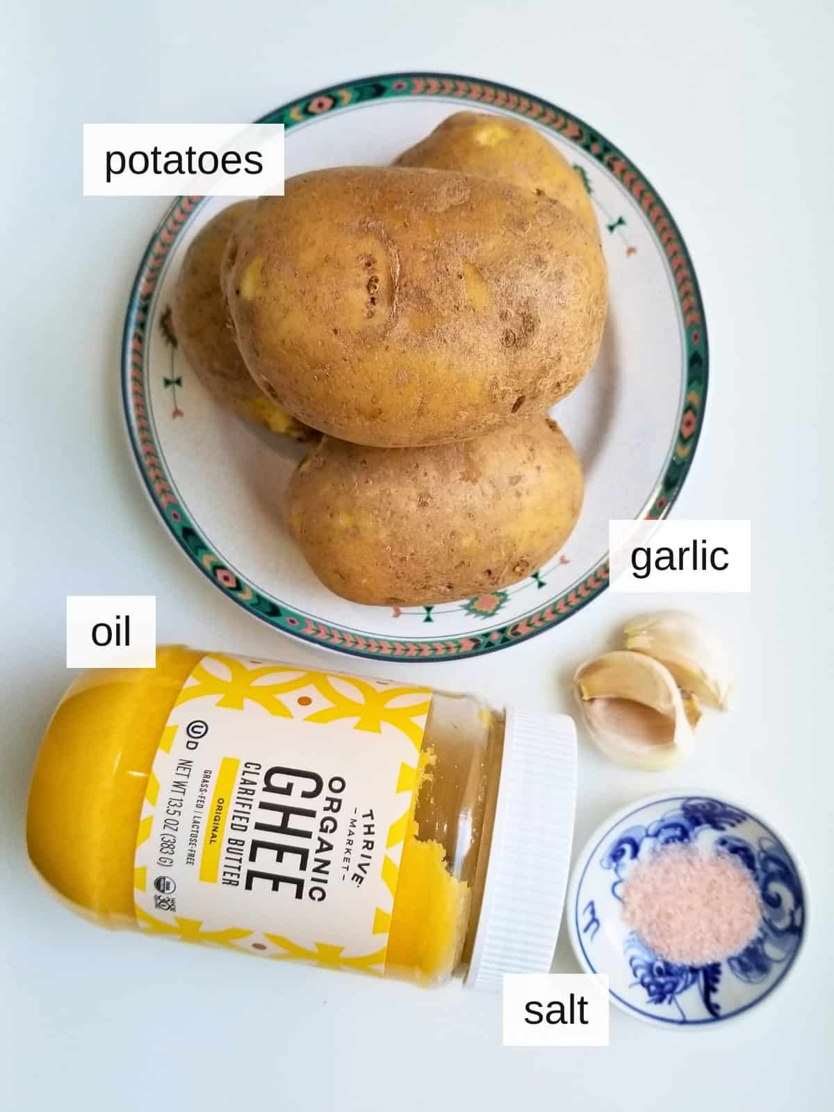 Ingredients for garlic smashed potatoes, including your oil of choice, potatoes, garlic, and salt.