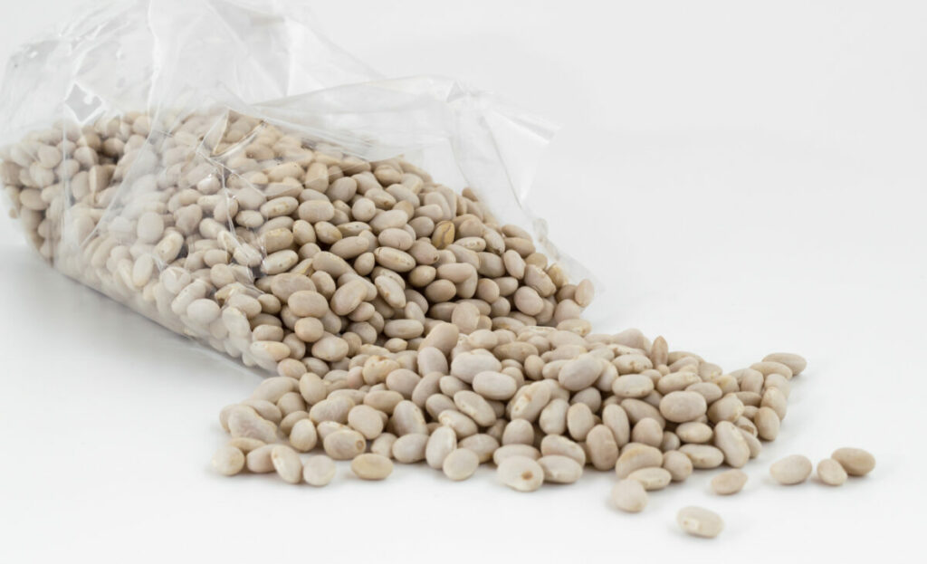 A plastic bag full of navy beans.