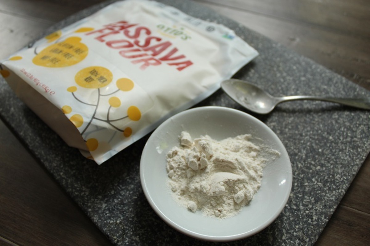 white bowl of cassava flour on a grey cutting board in front of a bag of Otto's cassava flour.