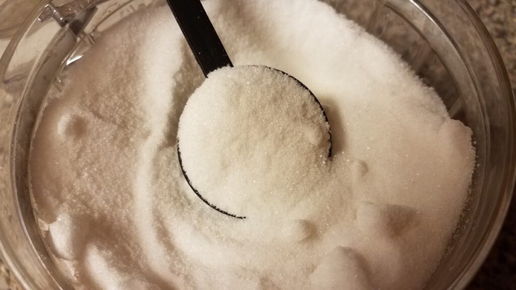 A scoop of white sugar.