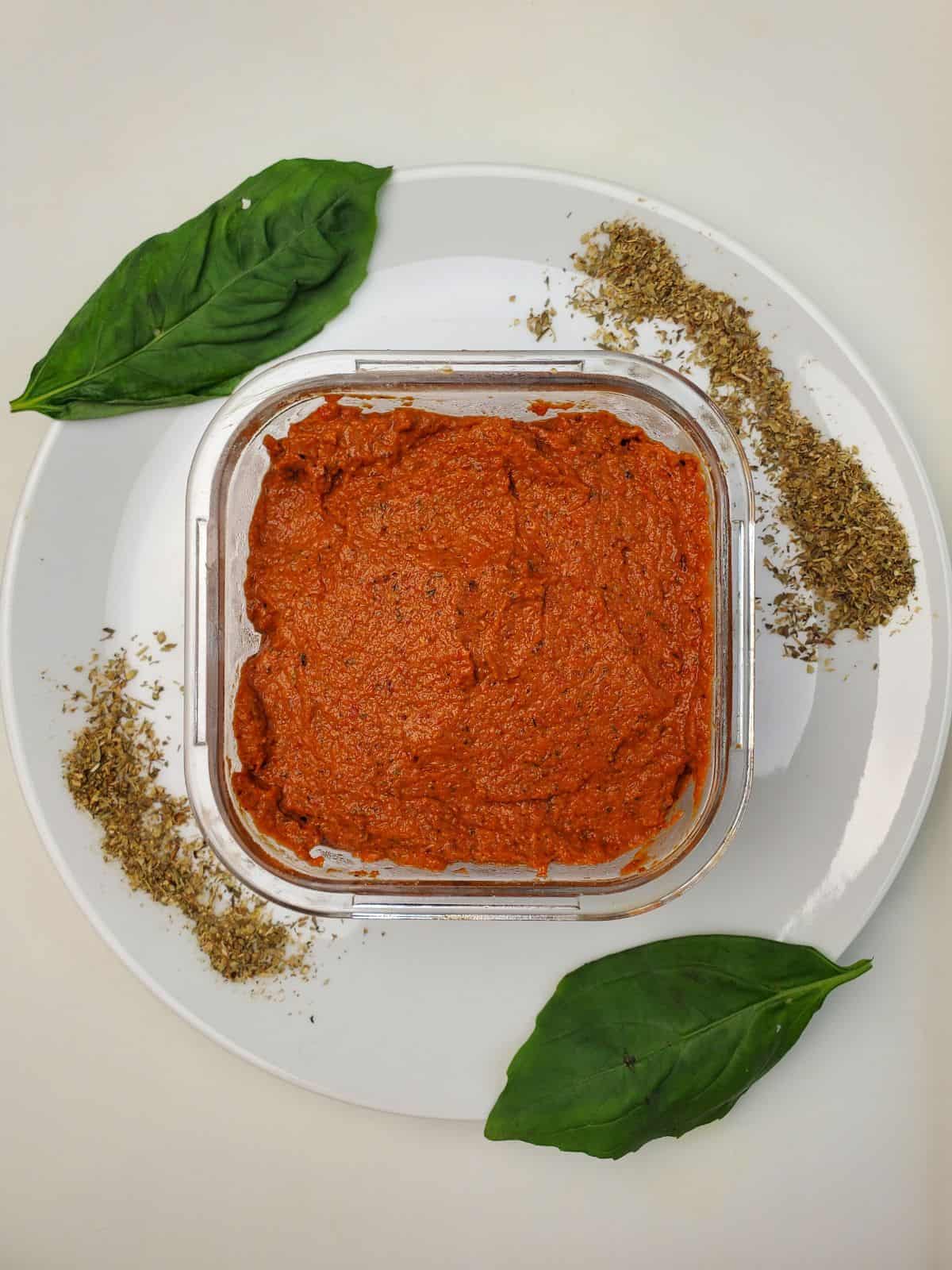 red pepper nomato sauce in a glass container