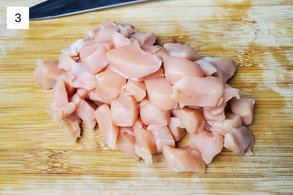 bite-sized chicken chunks on a wooden chopping board