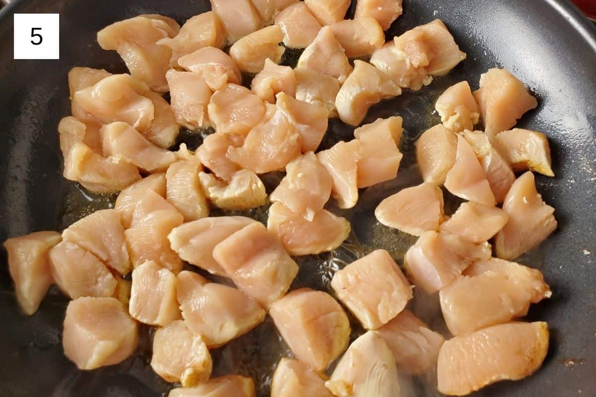 chopped chicken in a pan with heated butter