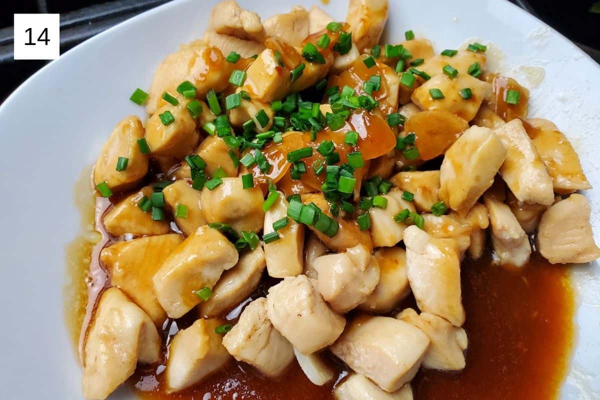 cooked honey butter chicken breast with sauce and chives on top