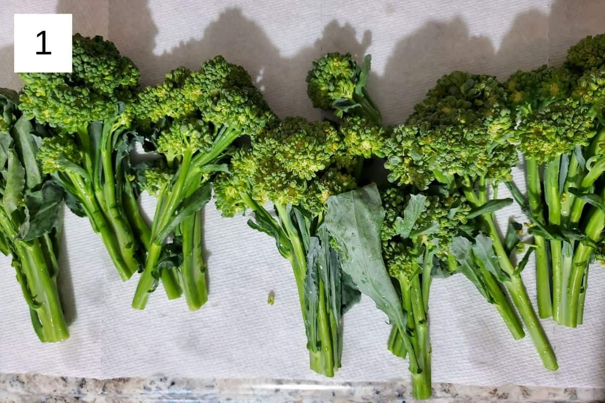 raw broccolini on a kitchen towel.