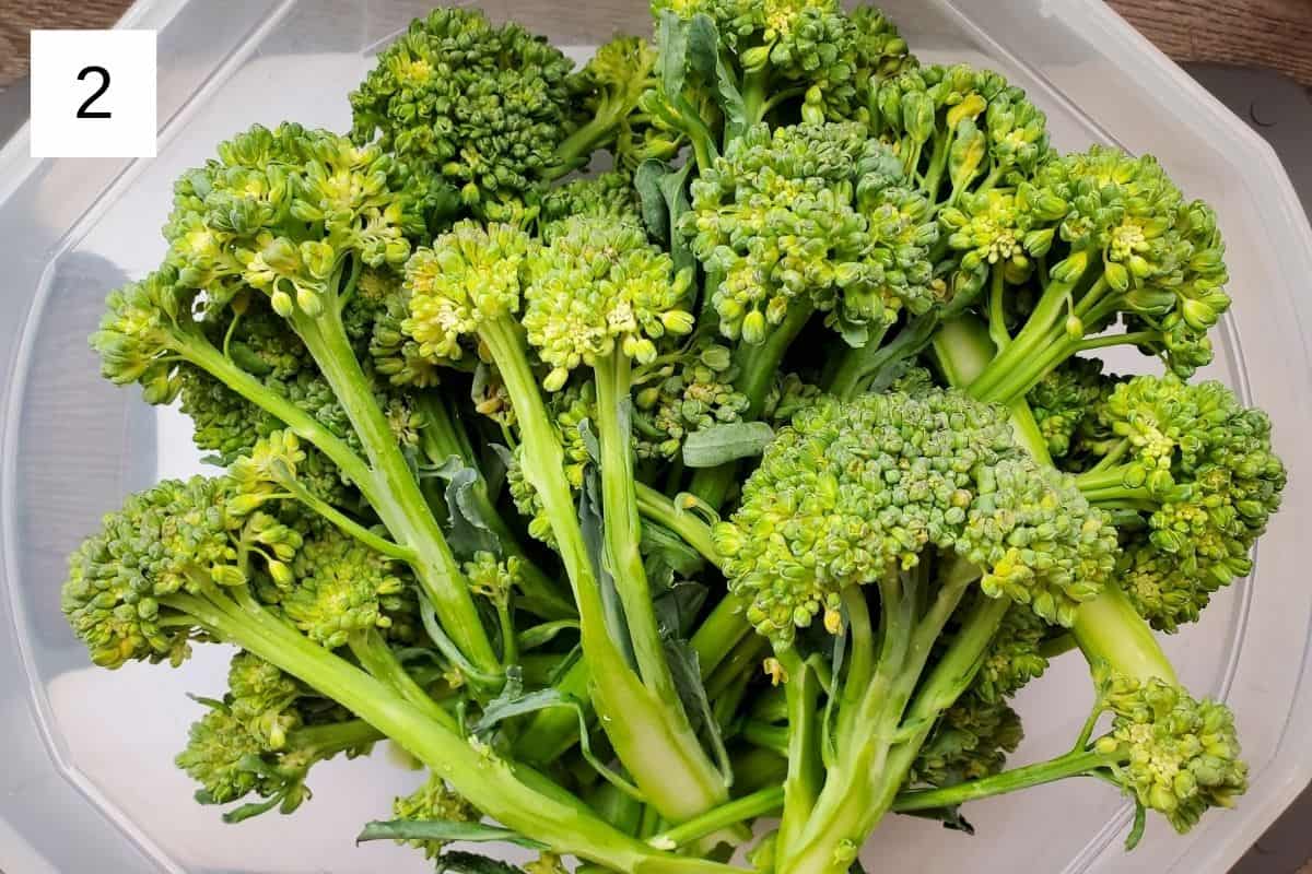raw broccolini in a large bowl.