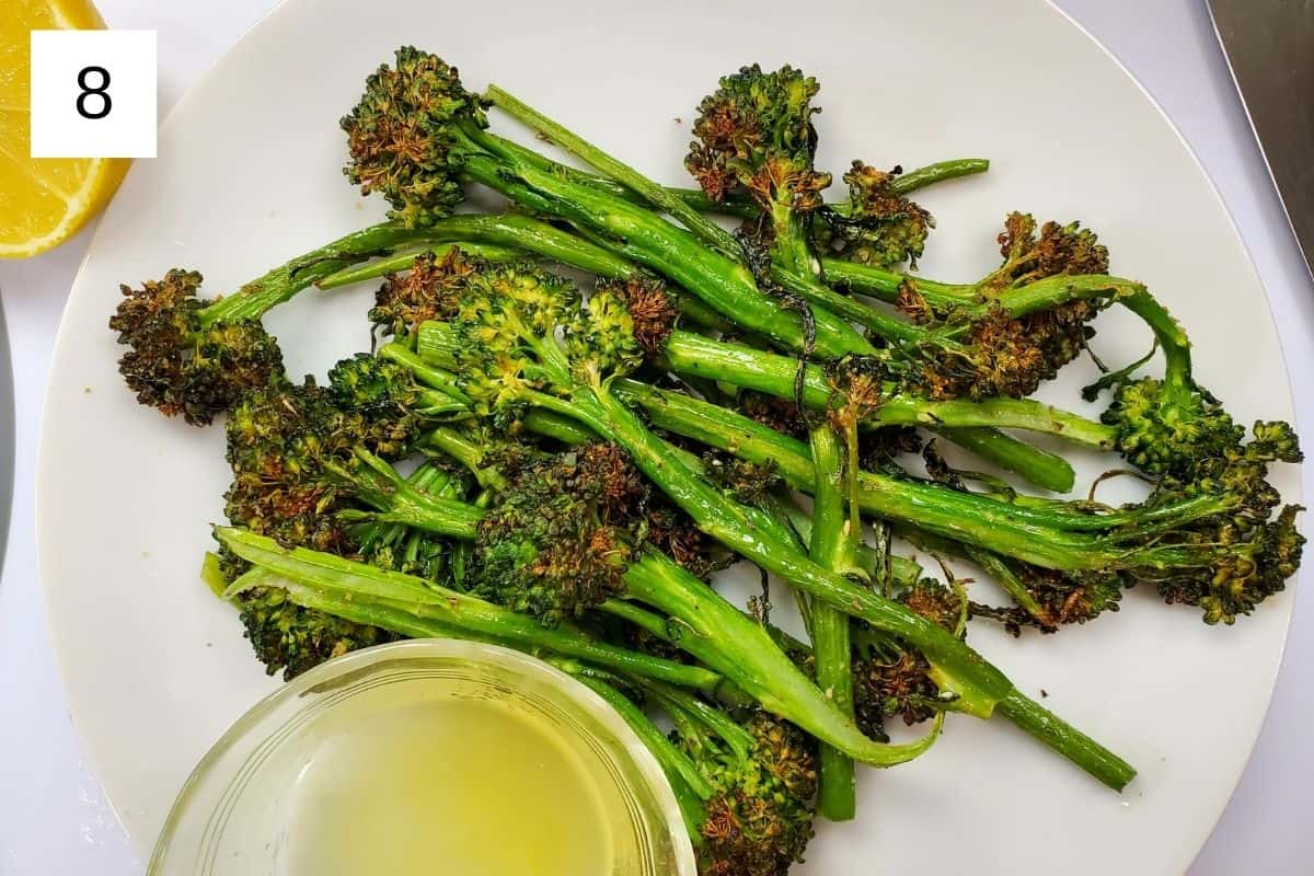 cooked broccolini on a white plate.