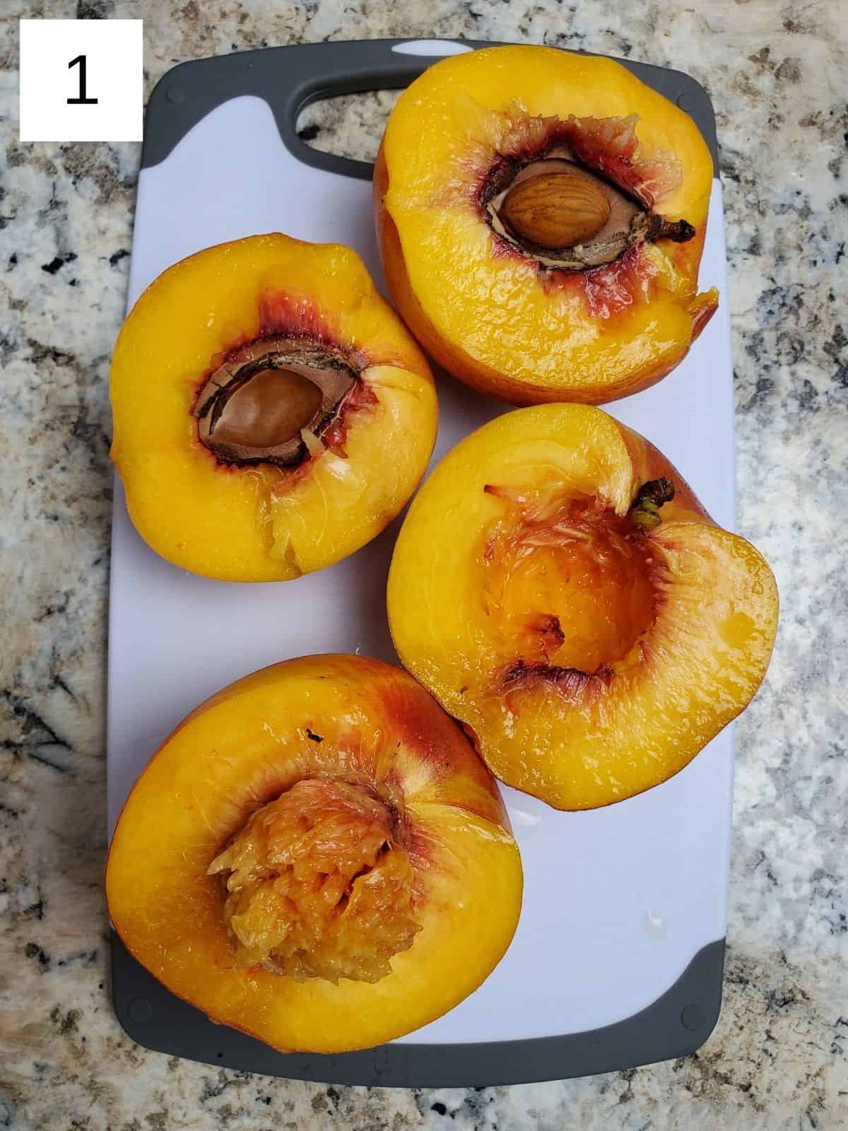 2 peaches, cut into halves on a cutting board