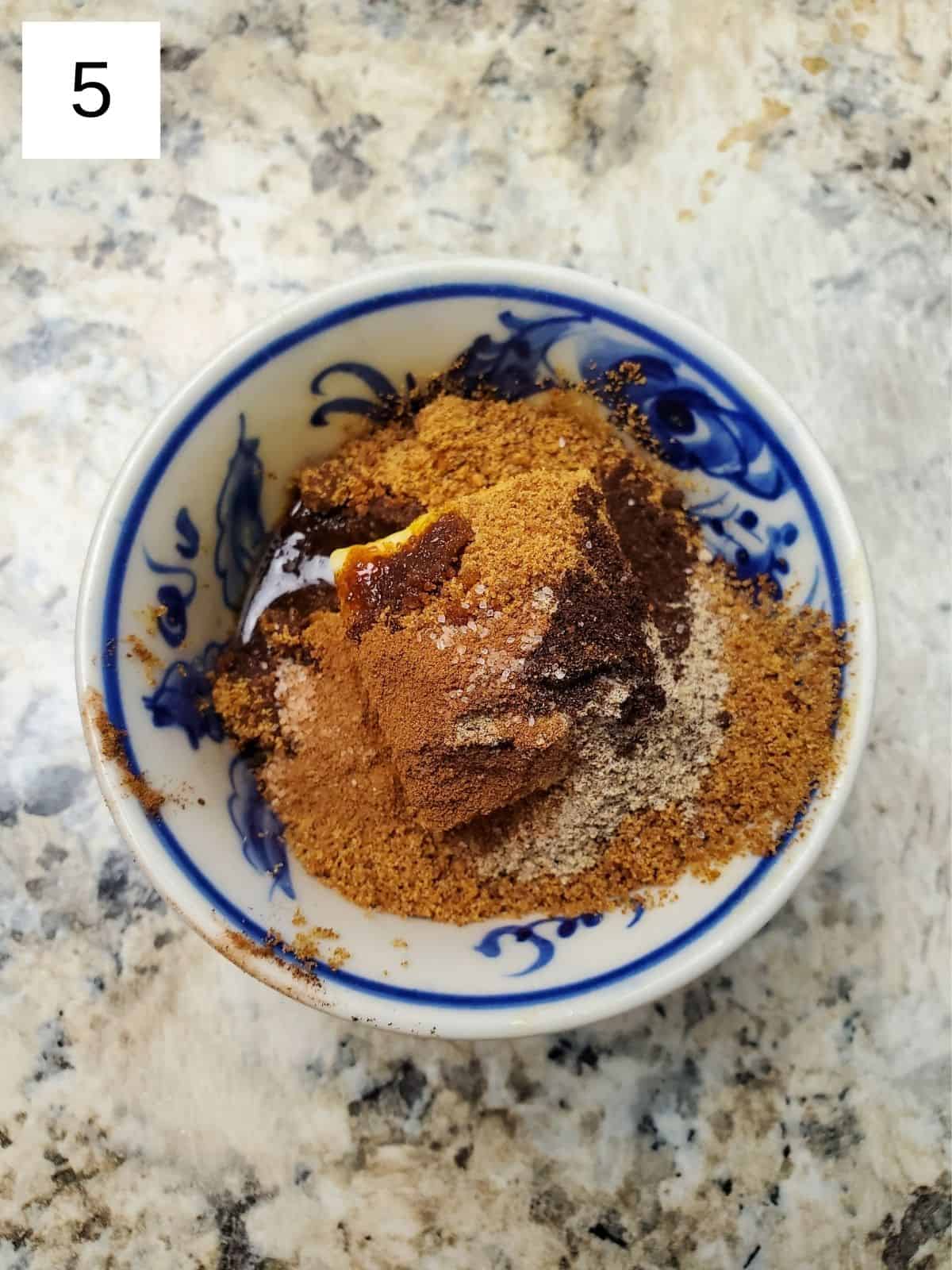 spiced butter mixture in a bowl with butter, coconut sugar, cardamom, and vanilla