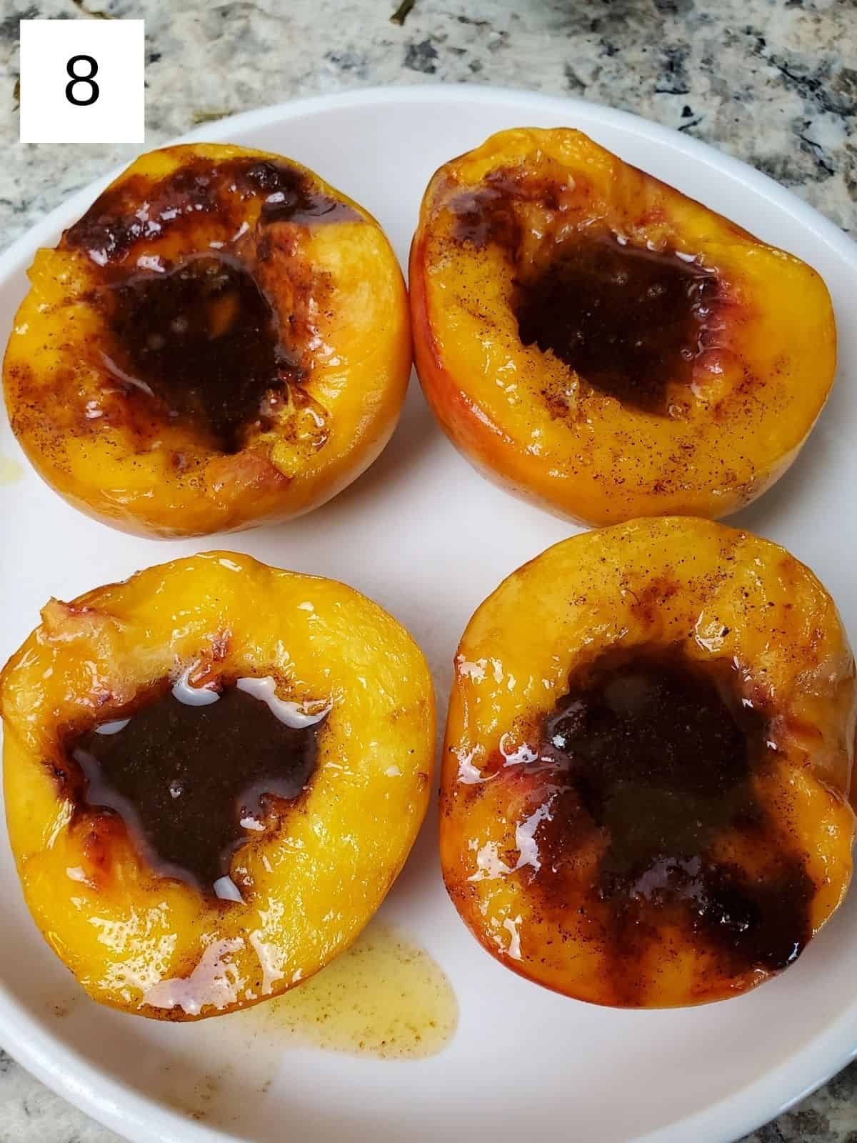 four halves of peaches with spiced butter mixture