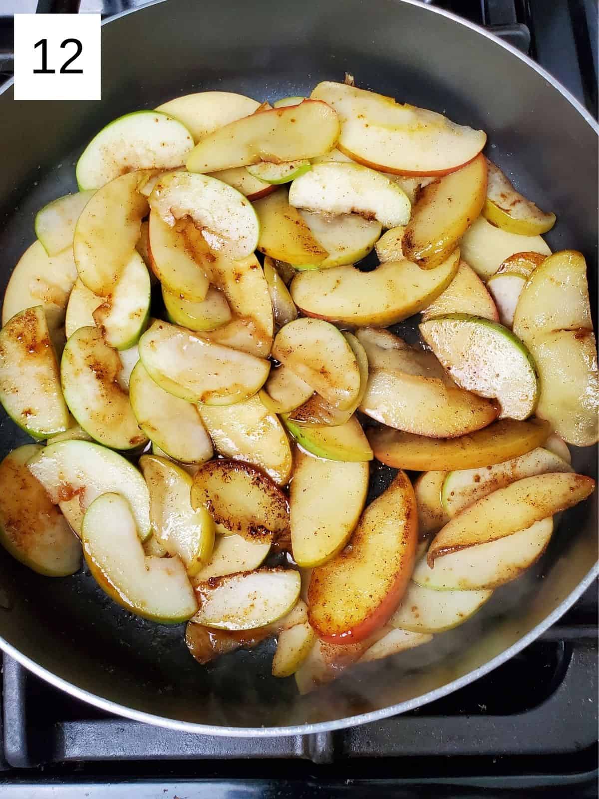 seasoned slices of apples in a pan.