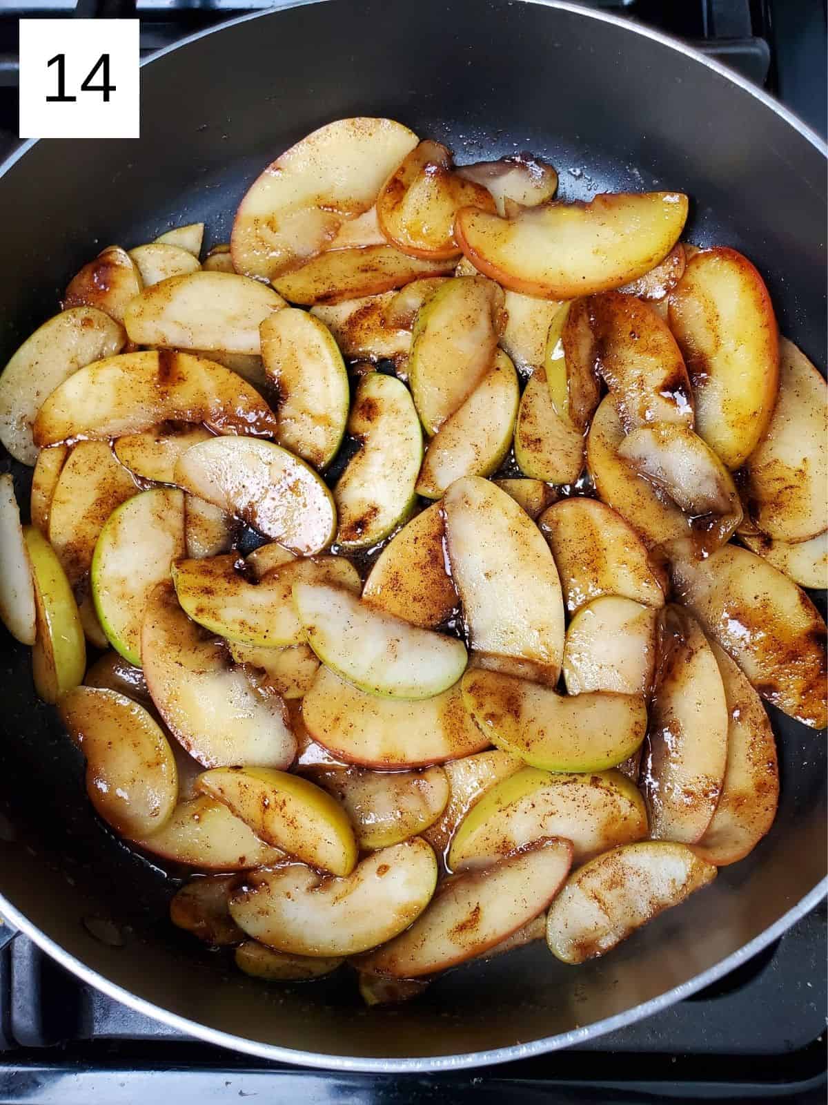 seasoned slices of apples in a pan.