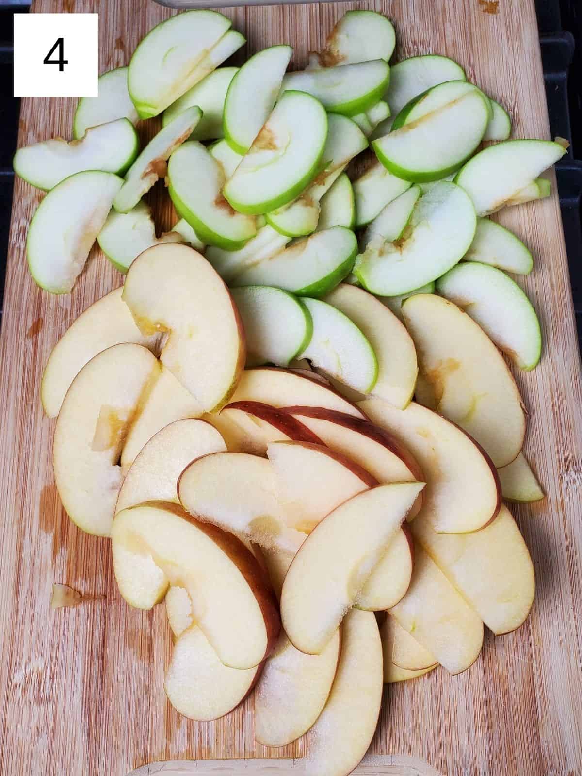 evenly cut slices of apples on a wooden cutting board.