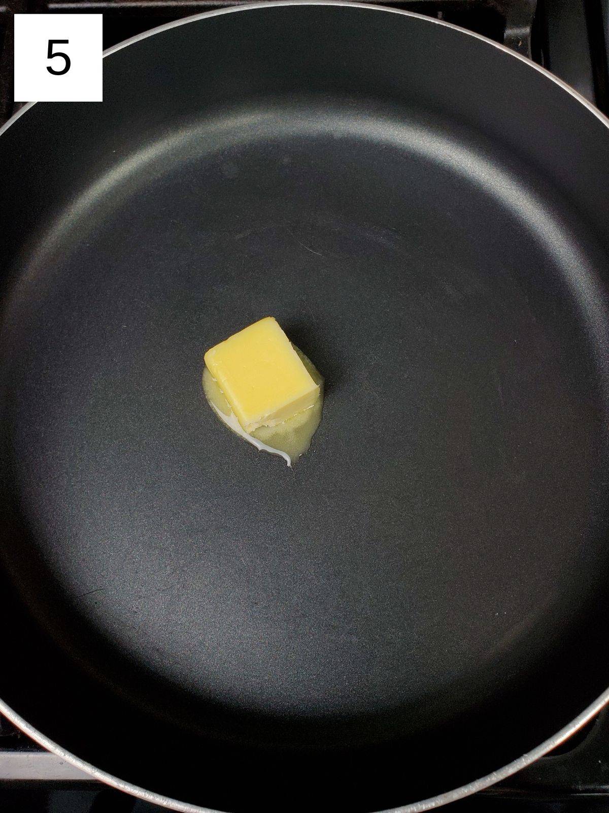 one cube of salted butter in a pan.