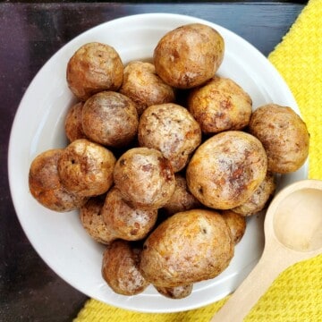 roasted baby potatoes with on a white plate.