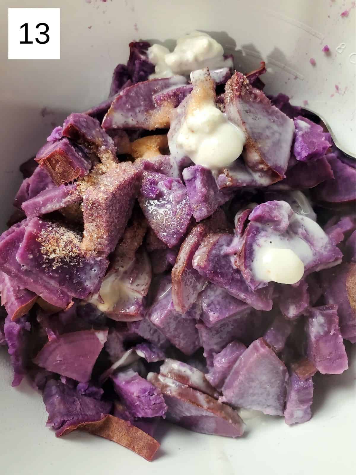 cooked pieces of purple sweet potatoes with salt and coconut milk in a bowl.