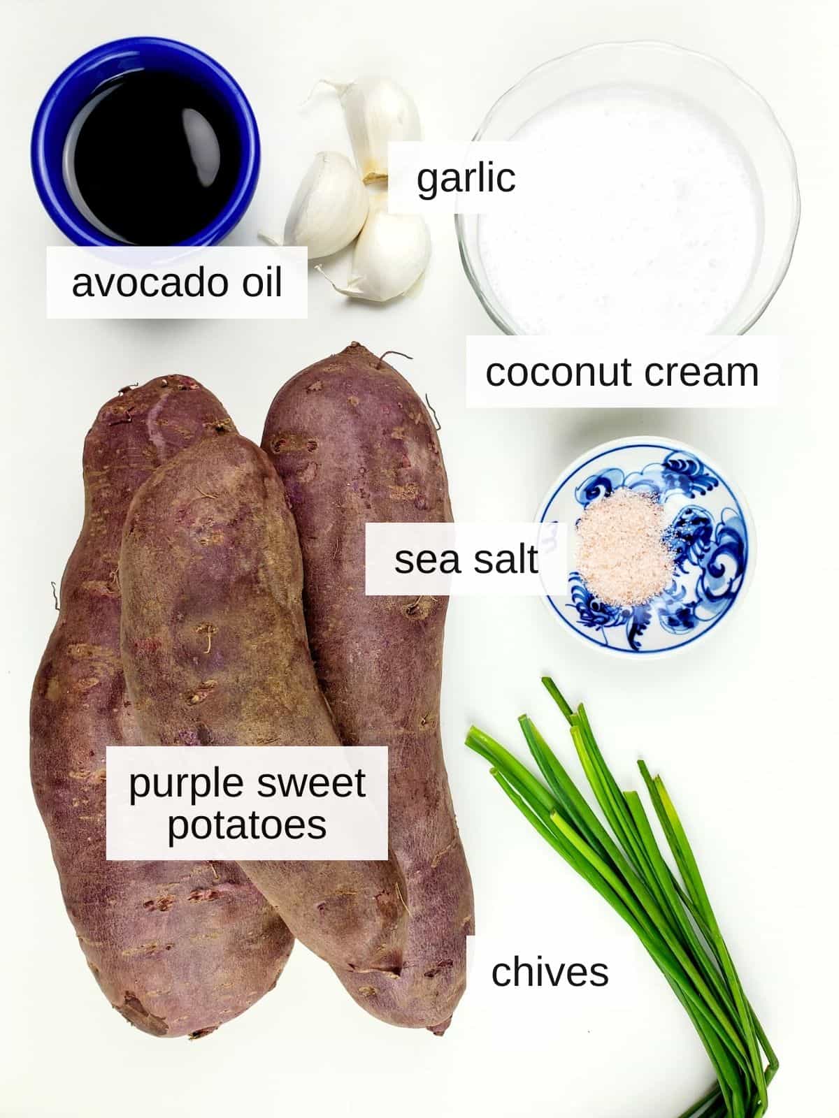 ingredients for mashed purple sweet potatoes, including avocado oil, garlic, coconut cream, sea salt, chives, and purple sweet potatoes.