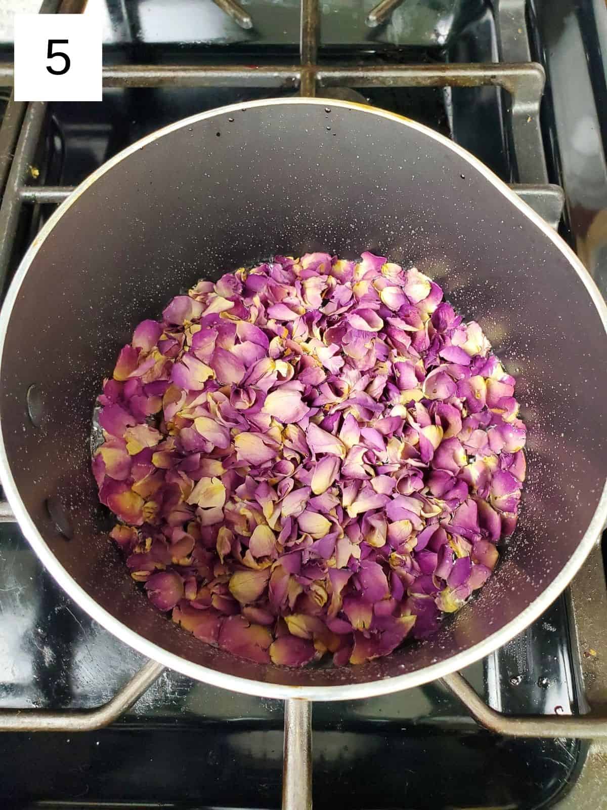 dried rose petals poured in a mixture of hibiscus and sugar