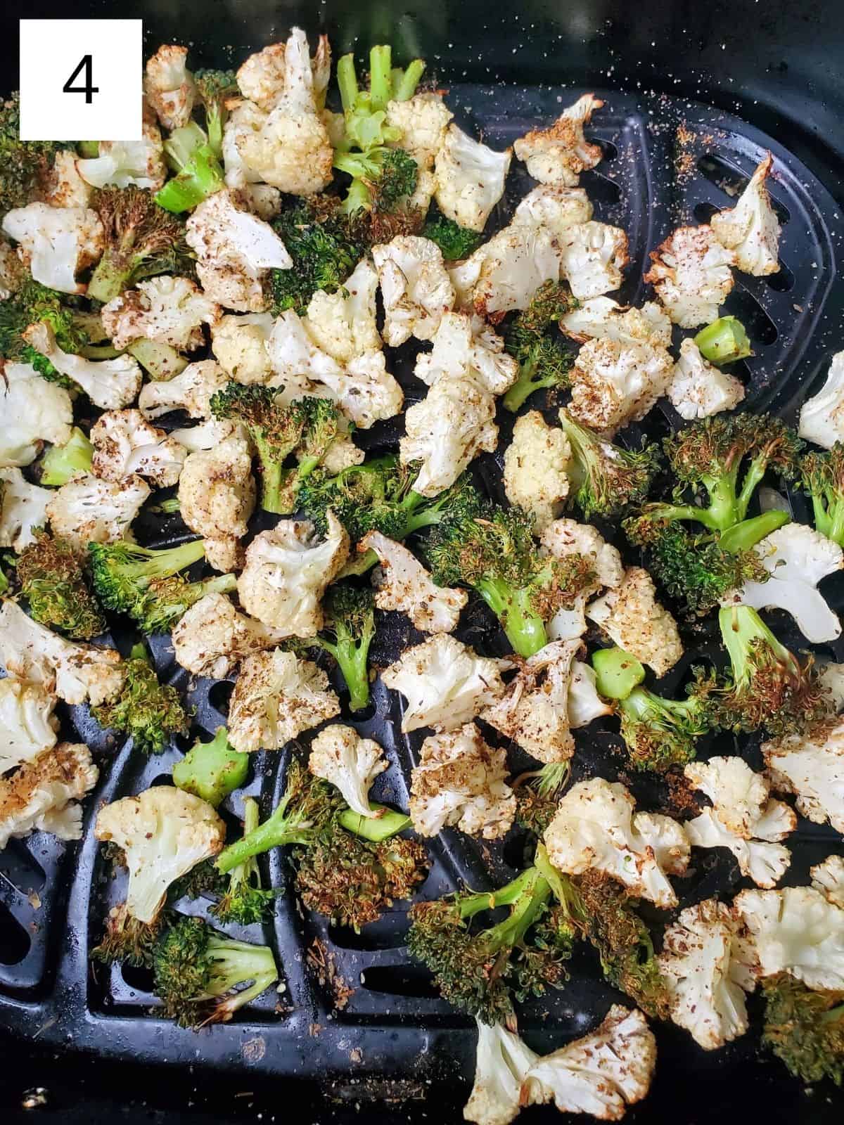cooked seasoned broccoli and cauliflower in an air fryer.
